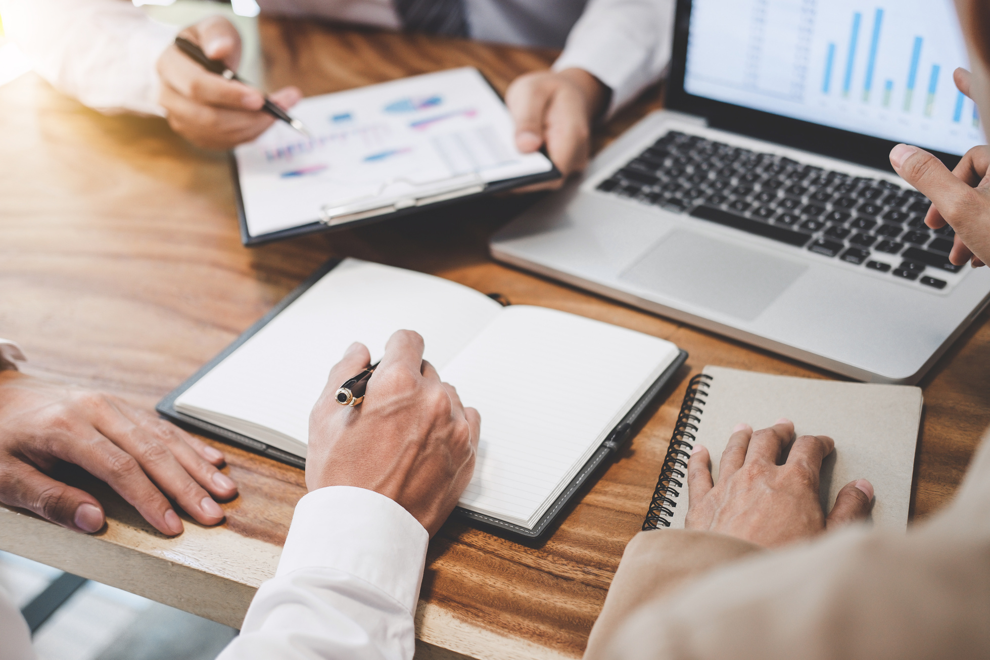 Business team working with new startup project plan and discussion information for financial strategy with laptop and digital tablet in a modern business lounge
